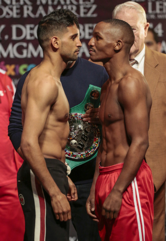 Amir Khan, left, and Devon Alexander face off during the official weigh-in at the MGM Grand Garden Arena in Las Vegas, Friday, Dec. 12, 2014. (Donavon Lockett/Las Vegas Review-Journal
