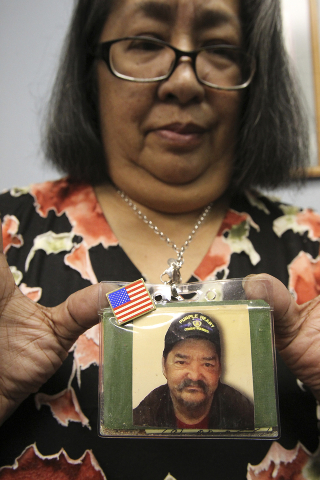 Johnnette Fafard, widow of Army Sgt. Raymond Fafard, shows a photo of her husband before an award ceremony honoring him at the Las Vegas office of Rep. Dina Titus Tuesday, Sep. 3, 2013. Fafard die ...