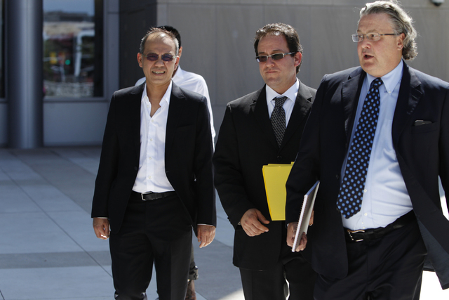 Paul Phua, left, walks to Lloyd George Federal Courthouse in Las Vegas with his attorneys Richard Schonfeld, center, and David Chesnoff, for his arraignment Tuesday, Aug. 5, 2014. (Erik Verduzco/L ...