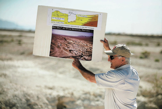 Stephen Rowland, professor of geology at UNLV, holds up a diagram and photo while guiding a tour of the proposed Tule Springs Fossil Beds National Monument Monday, March 17, 1014, in North Las Veg ...