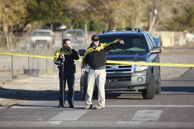 Las Vegas police investigate the scene of a fatal vehicle-pedestrian crash on Lake Mead Boulevard at Linn Lane, east of Nellis Boulevard, in Las Vegas on Tuesday, Dec. 9, 2014. (Chase Stevens/Las  ...
