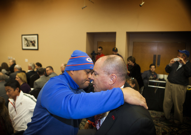 Supporter Ray Mook,left, embraces new UNLV's Men's football coach Tony Sanchez  during press conference to , Thursday, Dec. 11,2014, at Stan Fulton Building.  Sanchez, former Bishop Gorman High Sc ...