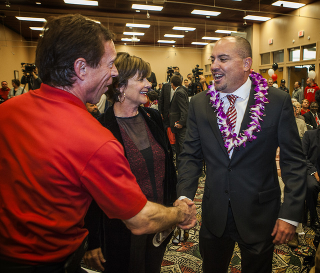 Rich Abajian, general manager at Findlay Toyota left, greets new UNLV's Men's football coach Tony Sanchez  during press conference,Thursday, Dec. 11,2014, at Stan Fulton Building. In the center is ...