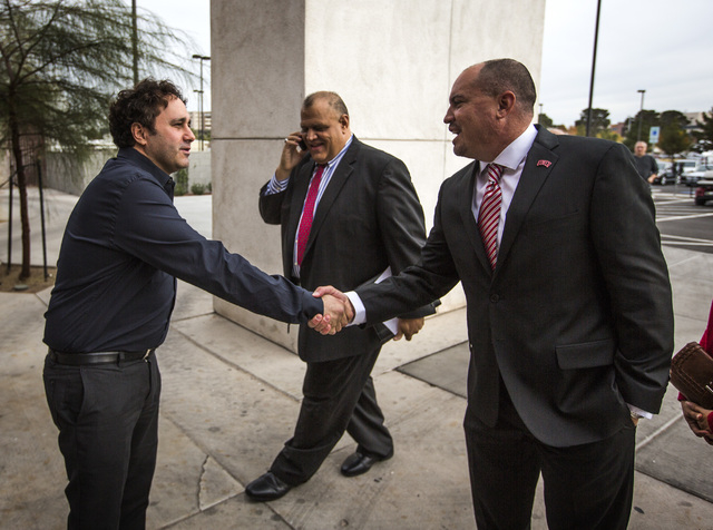 Former UNLV football player and business man George Maloof  greets Tony Sanchez,  the new  UNLV  men's football coach outside Stan Fulton Building on Thursday, Dec. 11,2014.  Sanchez, a former Bis ...