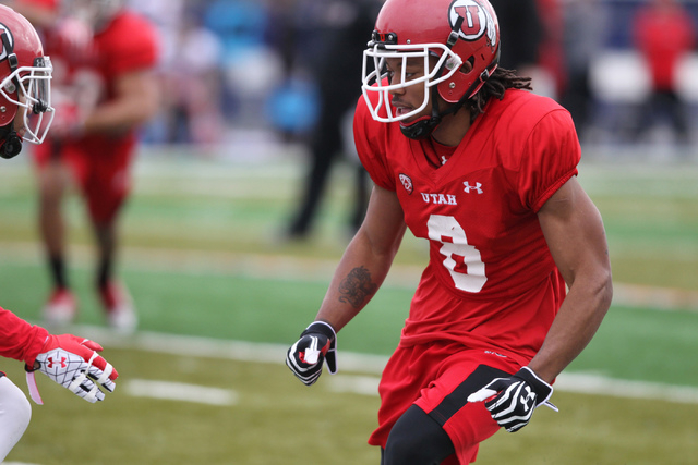 Utah wide receiver Kaelin Clay (8), center, runs a play during a team practice at Bishop Gorman Catholic High School in Las Vegas Wednesday, Dec. 17, 2014. Utah will play against Colorado State in ...
