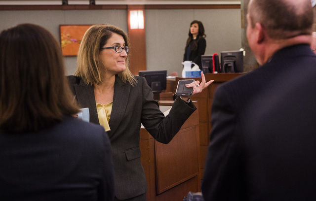 Clark County Chief District Judge Jennifer Togliatti, left, talks to counsel Tuesday, Dec. 16, 2014, at the Regional Justice Center after a settlement was reached in the $500 million civil damages ...