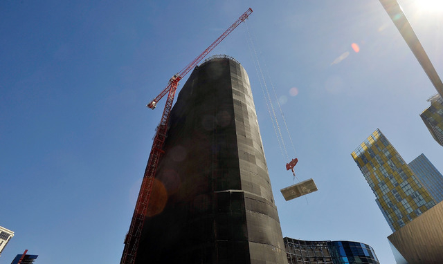 A tower crane lowers a concrete slab as the demolition continues of the unfinished Harmon Hotel tower on Monday, Sept. 22, 2014, in Las Vegas. The planned 47-story tower, part of MGM Resort Intern ...