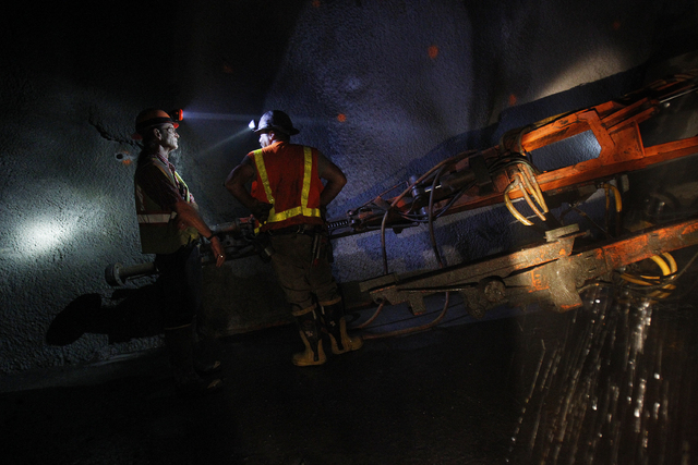 Workers work in a tunnel roughly 400 feet below ground at Lake Mead near Las Vegas Wednesday, June. 12, 2013. The Southern Nevada Water Authority will use the tunnel to link a third intake, still  ...