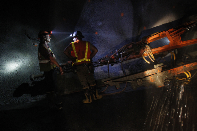 Workers work in a tunnel roughly 400 feet below ground at Lake Mead near Las Vegas Wednesday, June. 12, 2013. The Southern Nevada Water Authority will use the tunnel to link a third intake, still ...