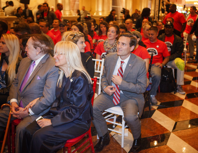 Nevada Attorney General-elect Adam Laxalt, right, sits behind multibillionaire Sheldon Adelson and his wife, Miriam, during the Salute our Troops welcome ceremony at The Venetian on Wednesday, Dec ...
