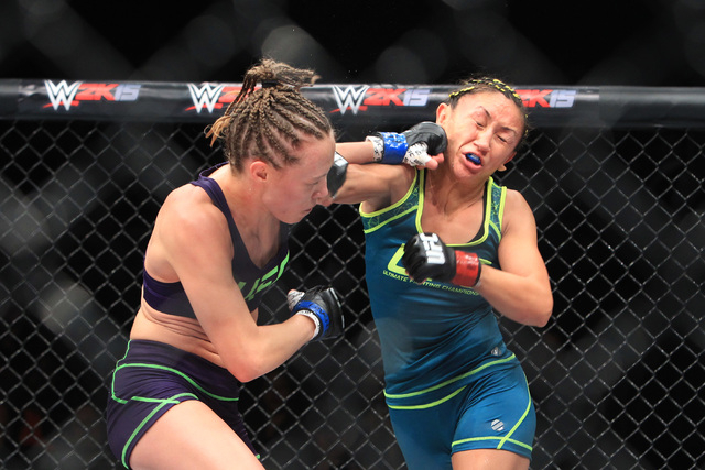 Carla Esparza is hit with a left by Rose Namajunas during their strawweight fight at The Ultimate Fighter finale Friday, Dec. 12, 2014 at the Palms. Esparza became the UFC's first female straw wei ...