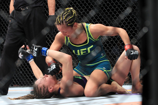 Carla Esparza mounts and throws head shots at Rose Namajunas during their strawweight fight at The Ultimate Fighter finale Friday, Dec. 12, 2014 at the Palms. Esparza became the UFC's first female ...