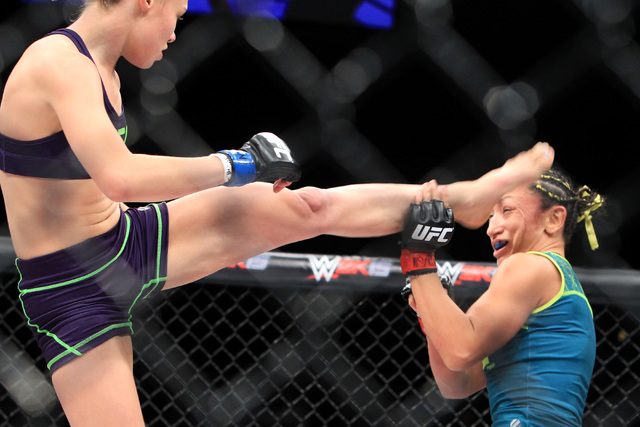 Rose Namajunas connects with a kick to the head of Carla Esparza during their strawweight fight at The Ultimate Fighter finale Friday, Dec. 12, 2014 at the Palms. Esparza became the UFC's first fe ...