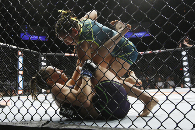Carla Esparza forces Rose Namajunas into the cage during their strawweight fight at The Ultimate Fighter finale Friday, Dec. 12, 2014 at the Palms. Esparza became the UFC's first female straw weig ...