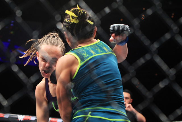 Carla Esparza connects with a right to the face of Rose Namajunas during their strawweight fight at The Ultimate Fighter finale Friday, Dec. 12, 2014 at the Palms. Esparza became the UFC's first f ...