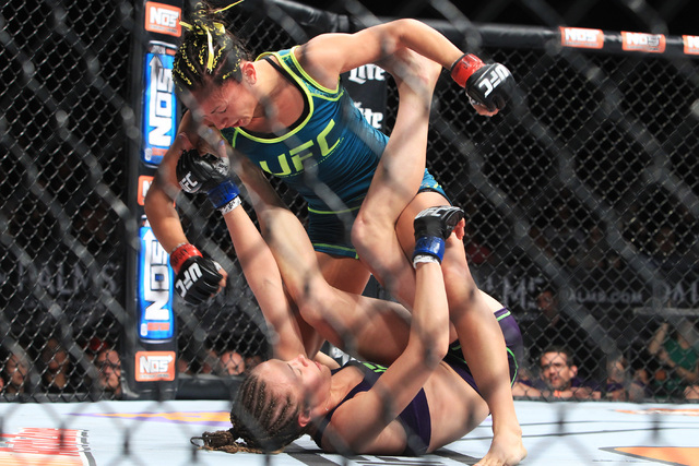 Carla Esparza rains punches down on Rose Namajunas during their strawweight fight at The Ultimate Fighter finale Friday, Dec. 12, 2014 at the Palms. Esparza became the UFC's first female straw wei ...