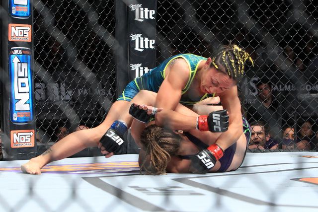 Carla Esparza lands an elbow to the head of Rose Namajunas during their strawweight fight at The Ultimate Fighter finale Friday, Dec. 12, 2014 at the Palms. Esparza became the UFC's first female s ...