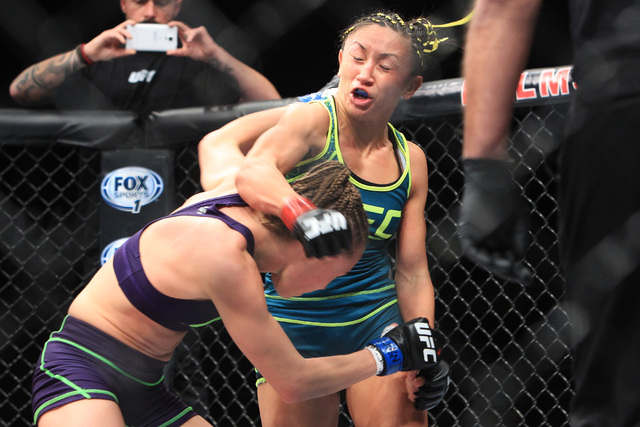 Rose Namajunas ducks a right from Carla Esparza during their strawweight fight at The Ultimate Fighter finale Friday, Dec. 12, 2014 at the Palms. Esparza became the UFC's first female straw weight ...