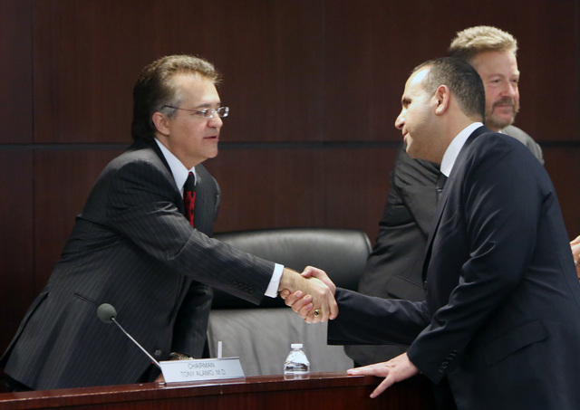 Sam Nazarian, CEO of SBE Entertainment, right, shakes hands with Chairman Tony Alamo, right,  after appearing before the Nevada Gaming Commission during a hearing as Nazarian seeks a gambling lice ...