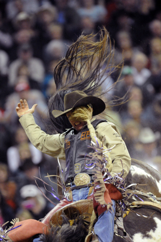 Saddle bronc rider Cody Wright of Milford, Utah, takes a wild ride