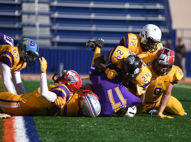 Team Sunrise defense sacks team Sunset quarterback Christian Tasi (17) during the 42nd annual West Charleston Lions Club Charity High School All-Star Football game played at the Bishop Gorman High ...
