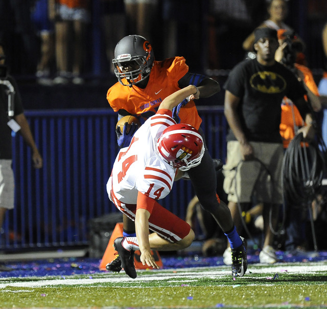 Bishop Gorman's Tyjon Lindsey runs over Brophy Prep punter Jack Katzman (14) while returning a punt in the first half of the Sollenberger Classic on Friday. (Josh Holmberg/Las Vegas Review Journal)