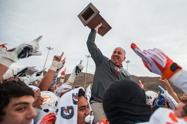 Bishop Gorman's Tony Sanchez, head coach, celebrates with his team after winning the NIAA Nevada State High School Division I Championship game against Reed on Saturday, Dec. 6, 2014 in Reno, Nev. ...