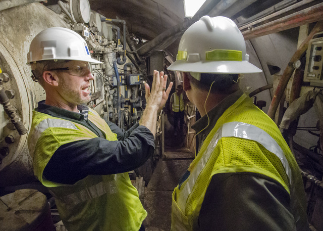 Bronson Mack, left, public information officer for Southern Nevada Water Authority, describes the tunnel bore machine during a tour of the third intake tunneling project at Lake Mead Tuesday Sept. ...