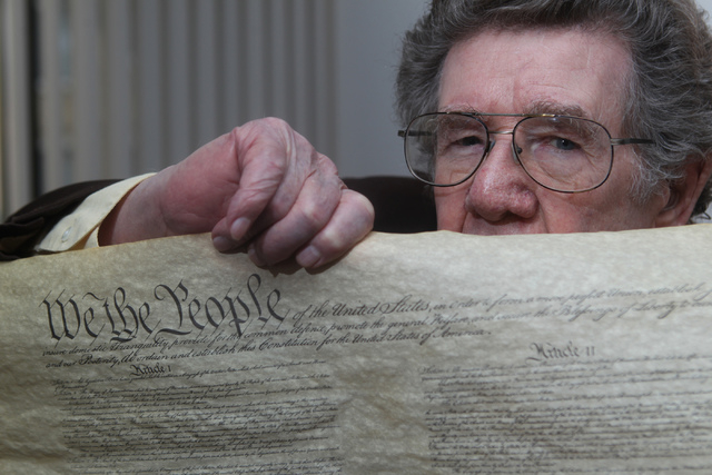 Korean War Army veteran Charles Mahoney poses for a portrait with a copy of the U.S. Constitution at his home in Las Vegas Thursday, Dec. 11, 2014. Mahoney claims the U.S. Constitution failed him ...