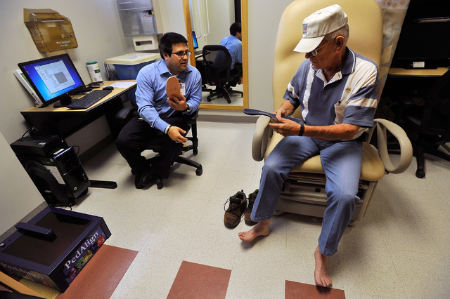 Prosthetic fitter Jesse Cintora Jr., left, works with retired Army Colonel Larry Masters on fitting a new pair of orthotic insoles at the VA Southern Nevada Healthcare System in North Las Vegas on ...