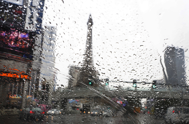 In this photo taken though rain drops on a car window shown Paris Hotel and Casino on Las Vegas Boulvard on Friday, Dec. 12, 2014. A weather system that is bringing heavy rainfall to Northern Cali ...