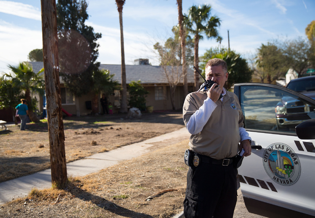 Craig Campbell checks the registration on a van, which a neighbor complained had been sitting idle for months, on Thelma Lane Friday, Jan. 16, 2015. (Samantha Clemens-Kerbs/Las Vegas Review-Journal)