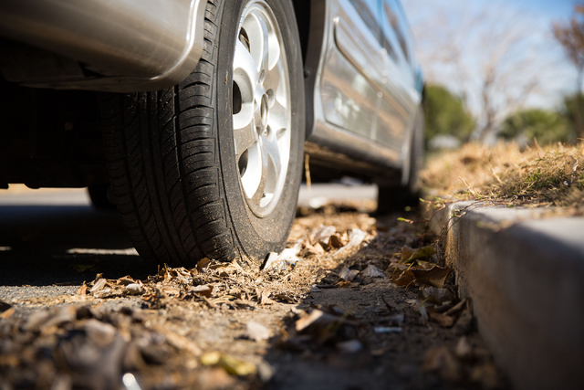 Debris unable to be cleaned by street sweepers near tires are indicators to parking enforcement officers of abandoned vehicles. A van located on Thelma Lane is given a notice by the city after a n ...