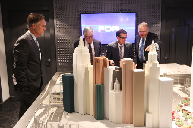 AEG Senior Vice President Mark Faber, left, businessman Bill Foley, Maloof family associate Tony Guanci and Peter Sadowski from Fidelity National Financial look over a model of the Las Vegas Arena ...