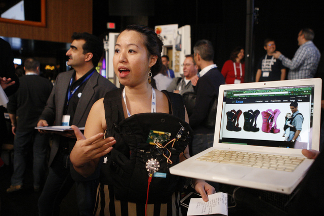 Christy Mahlow, member of the Interactive Design Cafe team, gives a presentation of her bluetooth and Wi-Fi connecting baby carrier WiSnug which monitors a baby's heart beat during the 2015 AT&T H ...