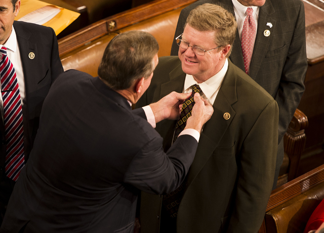 Rep. Cresent Hardy, R-Nev., adjusts the tie of fellow Nevada Republican Rep. Mark Amodei on the floor of the U.S. House as they await the start of the 114th Congress on Tuesday.  (Special to Steph ...