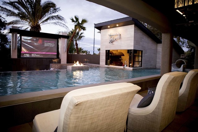 The home's pool area features a 165-inch, 12-foot-wide outdoor movie screen. (Tonya Harvey/Real Estate Millions)