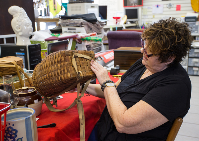 Renee Poole sorts through new items Jan. 12 at Not Just Antiques, 1422 Western Ave. Poole, an estate liquidator, owns the business with her daughter Jessica. (Donavon Lockett/View)
