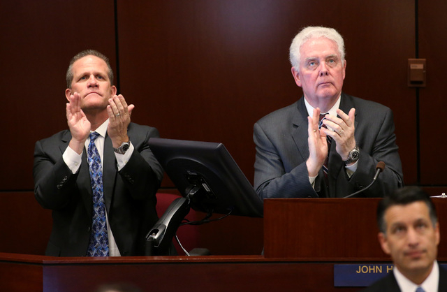 Lt. Gov. Mark Hutchison, left, and Assembly Speaker-elect John Hambrick, R-Las Vegas, acknowledge people in the crowd during Gov. Brian Sandoval's State of the State address at the Legislative Bui ...