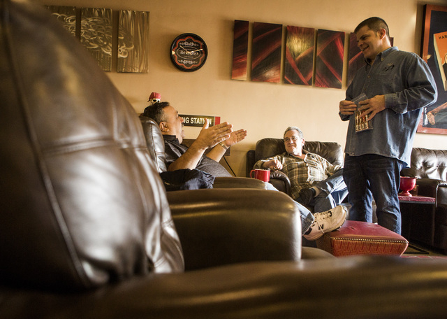 Michael Abdoulah, right, owner of  En Fuego Cigars & Lounge, 328 West Sahara Avenue, talks to costumers Joe Fallico, left, and Dave Moretti on Wednesday, Jan. 28, 2015. Gov. Brian Sandoval is prop ...