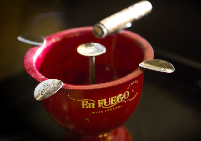 A cigar sits on an ashtray Wednesday, Jan. 28, 2015 at En Fuego Cigars & Lounge, 328 West Sahara Avenue. Gov. Brian Sandoval is proposing to raise taxes on tobacco.(Jeff Scheid/Las Vegas Review-Jo ...