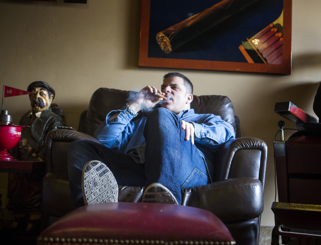Michael Abdoulah, owner of  En Fuego Cigars & Lounge, 328 West Sahara Avenue, relaxes with a cigar on Wednesday, Jan. 28, 2015. Gov. Brian Sandoval is proposing to raise taxes on tobacco.(Jeff Sch ...