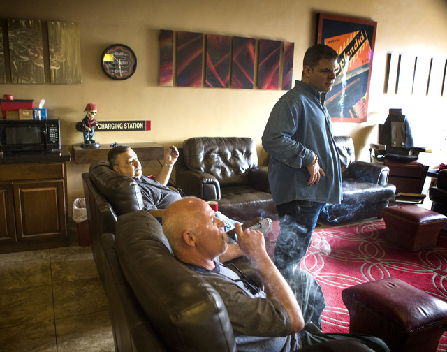 Michael Abdoulah, right, owner of En Fuego Cigars & Lounge, 328 West Sahara Avenue, talks to costumers Joe Fallico, left, and James Berns on Wednesday, Jan. 28, 2015. Gov. Brian Sandoval is propo ...