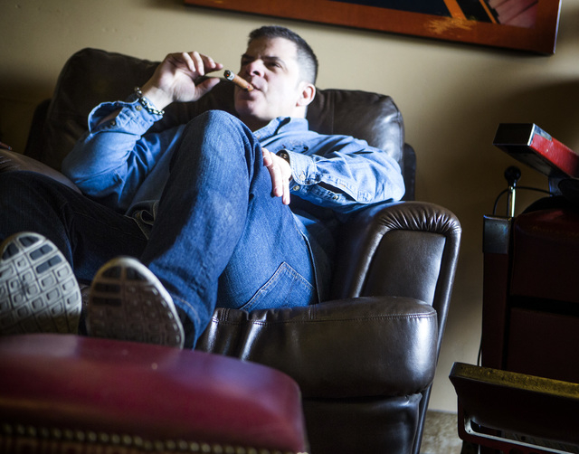 Michael Abdoulah, owner of En Fuego Cigars & Lounge, 328 West Sahara Avenue, relaxes with a cigar on Wednesday, Jan. 28, 2015. Gov. Brian Sandoval is proposing to raise taxes on tobacco.(Jeff Sch ...