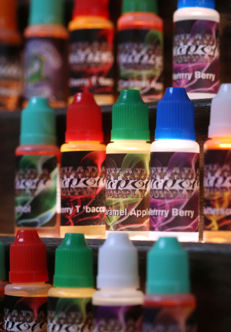 Shelves of e-cigarette flavors available at the Nevada Vapor Supply in Carson City, Nev., on Tuesday, Jan. 27, 2015. Cigarette taxes and regulations on e-cigarettes will be part of the legislative ...