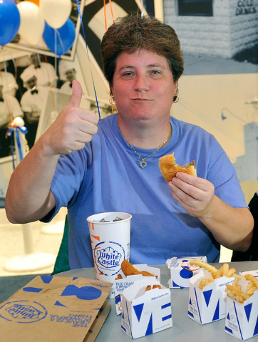 Linda Kitchel gives her approval after taking her first bite of a White Castle burger during the grand opening of White Castle's newest and only location west of the Rocky mountains in Las Vegas o ...