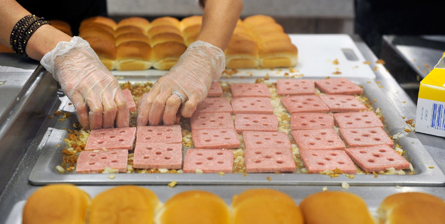 Lisa Ingram, president of White Castle, prepares slider burgers during the grand opening of the hamburger chain's newest and only location in Nevada on Tuesday, Jan. 27, 2015. (David Becker/Las Ve ...