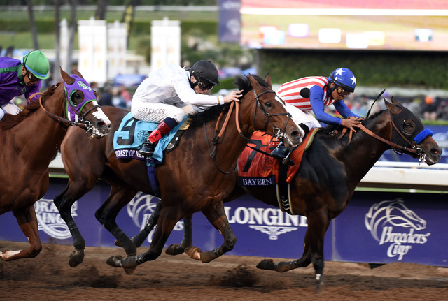 Martin Garcia aboard Bayern leads Jamie Spencer aboard Toast of New York and Victor Espinoza aboard California Chrome to the finish in race twelve during the 2014 Breeders' Cup Championships at Sa ...