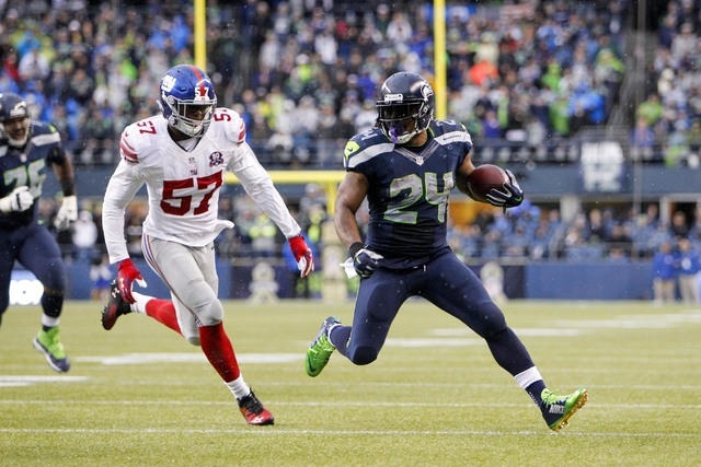 Nov 9, 2014; Seattle, WA, USA; Seattle Seahawks running back Marshawn Lynch (24) eludes a tackle by New York Giants outside linebacker Jacquian Williams (57) on a run during the fourth quarter at ...
