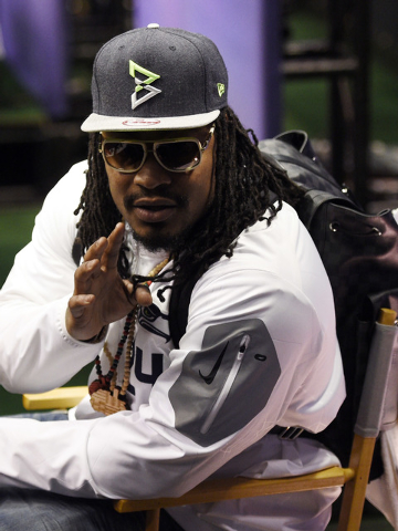 Jan 27, 2015; Phoenix, AZ, USA; Seattle Seahawks running back Marshawn Lynch sits at his podium during media day for Super Bowl XLIX at US Airways Center. (Kyle Terada-USA TODAY Sports)